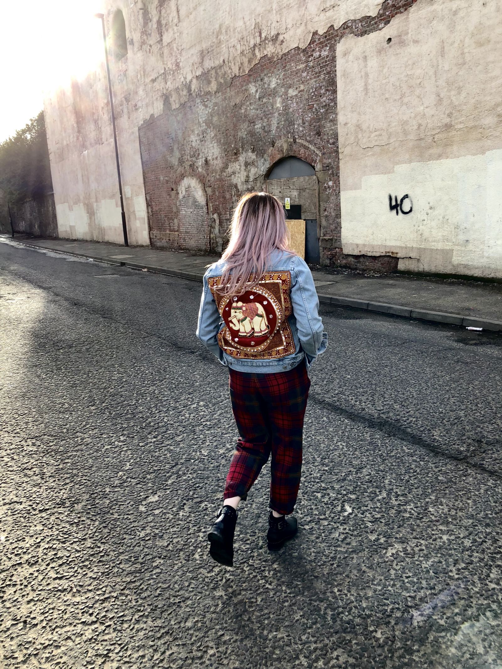 fashion blogger Pixie Tenenbaum wears a denim jacket by Flaura Rose with red elephant design on back