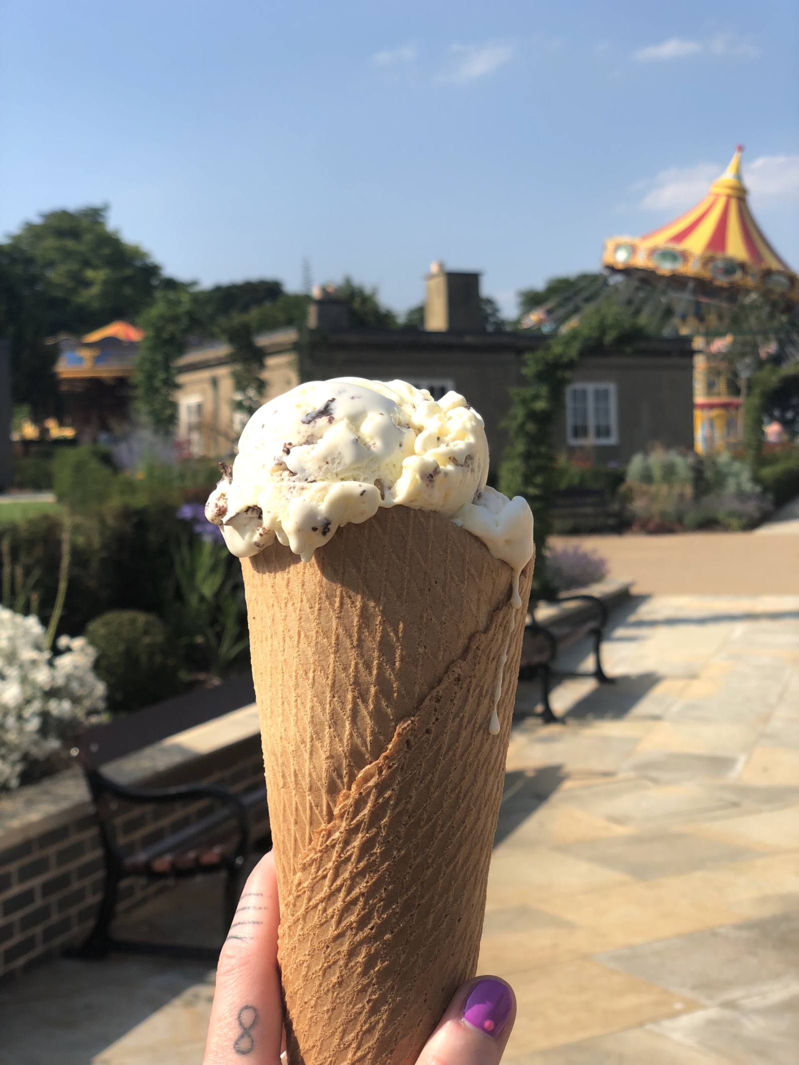 another huge ice cream at Wicksteed Park! This one is held up to camera with the carousel showing in the background